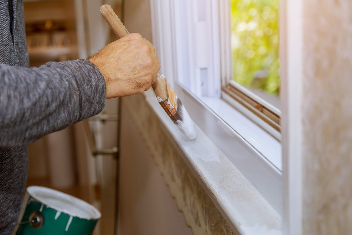 Worker Painting Window Frame with White Color